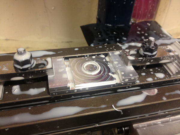 Die being machined from rectangular aluminum blank on CNC mill